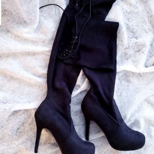 Stylish lace tie black sued thigh high boots.